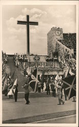 People bearing a variety of flags marching in front of a large Cross at Olympic Stadium in Berlin Germany Postcard Postcard Postcard