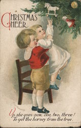 Christmas Cheer - Two Children Playing with Christmas Ornaments on a Tree Postcard