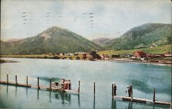 Palmer Lake dock with people fishing and town in view across the lake Colorado Postcard Postcard Postcard