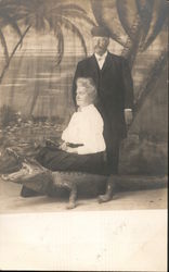 Man with Woman sitting on stuffed alligator Postcard