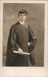 Young man in graduate robes, hat and holding diploma School and Class Photos Postcard Postcard Postcard