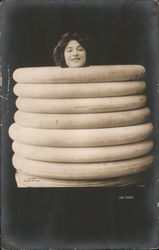 Lee Tires - Woman in Stack of Tires Postcard