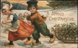 A joyous Christmastide - Dutch boy & girl pulling sled with holly on it Children Postcard Postcard Postcard