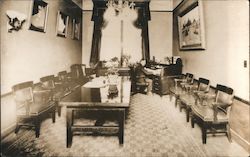 Man seated at roll top desk in meeting room Postcard