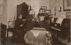 A family of four performing musical instruments together. Denmark Postcard Postcard Postcard