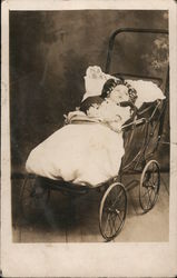 Baby strapped in open baggy buggy, photo studio Babies Postcard Postcard Postcard