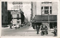 Francisco I. Madero Mexico Street with Mid-20th Century Vehicles and Ad Signage for Corona Modelo Sanborns and Menstril Postcard