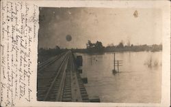 Railroad track over flooded river, man, setting sun, telephone poles Trains, Railroad Postcard Postcard Postcard