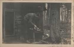 Hunter on the Porch of a Cabin Dressing His Kill Postcard