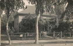 House with fenced yard, trees, baby in a carriage Buildings Postcard Postcard Postcard