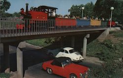 The Nut Tree Railroad Train on trestle as real cars drive under Vacaville, CA Postcard Postcard Postcard