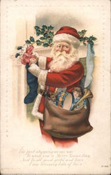 Santa Claus filling a stocking Postcard Postcard Postcard