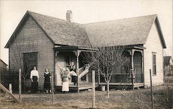 Women and children in front of a house Postcard