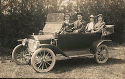 Four Men Wearing Hats in a Model T Postcard