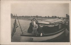 Group of people on small boat Postcard