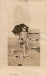 Woman in Housecoat, Ruffled Bonnet, Umbrella with Dog in Front of a Barn Postcard