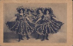 Four Women Showing Off Black Dresses adorned with Flowers Postcard