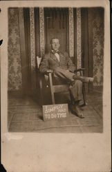 Man in Chair with Sign "I Simply Had To Do This" Arts & Crafts Men Postcard Postcard Postcard