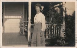 Woman in front of her house Postcard