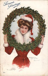 Season's Greetings - A Woman in a Santa Hat with a Wreath Christmas Postcard Postcard Postcard