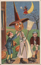 Two Boys Help Third Boy in Costume of Witch with Pumpkin Head, The Witch Halloween Postcard Postcard Postcard