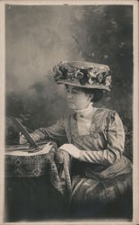 Woman Reads at Table Postcard