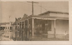 Outside of Shops with Flooding Postcard