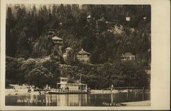 A boat in a river in front of a mountain Postcard