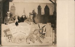 Four People Posing Behind a Sign Postcard