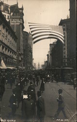 Old Glory - A Flag Flying Over a Busy Street Postcard