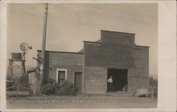 A Man Standing in a Large Opening in a Building Postcard