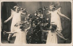 Four Girls Dressed as Angels Smelling Flowers Postcard