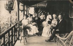 Group of people sitting on a balcony porch Postcard