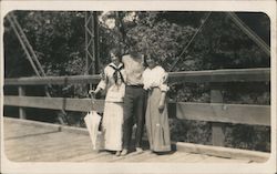 A Man with His Arms Around Two Women Postcard