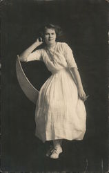 Kate Felkamp Poses on a Crescent Moon Postcard