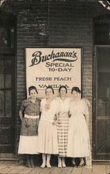 Four Women Standing in Front of Buchanan's Sign Postcard