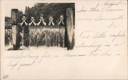 Five Girls Leaning Against a Fence Postcard