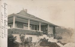 A Woman on the Porch of a House Postcard