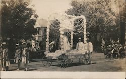 A Young Girl Standing in the Middle of a Parade Float Postcard