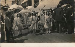 Young Girls pulling float dressed in white Postcard