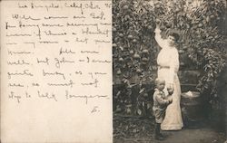 Woman and Child in a garden picking Oranges Postcard