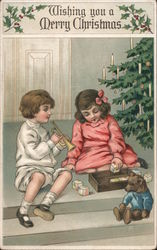 Wishing you a Merry Christmas / two children playing under Christmas tree Theodore Roosevelt Postcard Postcard Postcard