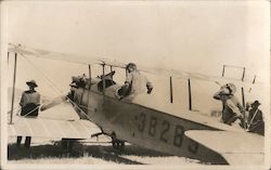 Men Standing Around a Plane Postcard