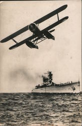 One engine biplane with battleship in background Air Force Postcard Postcard Postcard