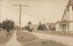 Horse drawn wagon on dirt street Postcard