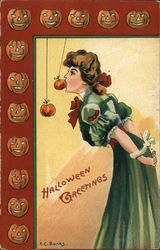 Halloween Greetings. Young woman bobbing for apples. E.C. Banks Postcard