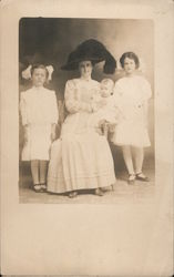 A Woman Holding a Baby and a Girl on Each Side of Her Postcard