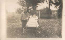 Boy next to baby in stroller Postcard