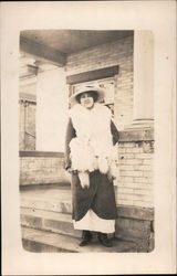 Woman in a big hat with a real fur scarf Postcard