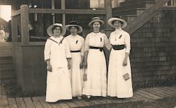 Four women in white with ribbon pins on blouses on a boardwalk Postcard Postcard Postcard